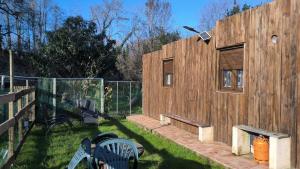een houten gebouw met een hek in een tuin bij Pontevedra's House in Pontevedra