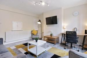 a living room with a couch and a table at The Serene Flat W Free Street Parking in Hackbridge