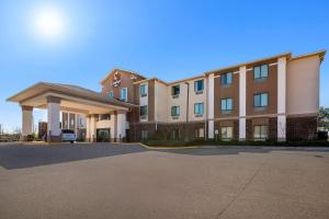 a large building with a parking lot in front of it at Comfort Inn New Orleans Airport South in Saint Rose