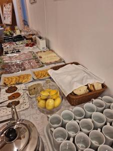 a table topped with lots of different types of food at Pensiunea Tinelu Brașov sacele in Braşov