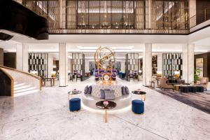 a lobby of a hotel with a ferris wheel at Waldorf Astoria Kuwait in Kuwait