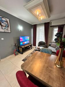 - un salon avec une table et une télévision dans l'établissement Elite Rezıdence, à Alanya