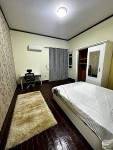 a bedroom with a bed and a table and a window at High-Ceiling Cozy Appartment in Cairo