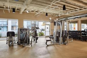 a gym with several treadmills and cardio machines at Avatar Hotel Santa Clara, Tapestry Collection by Hilton in Santa Clara