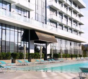 a hotel with a swimming pool in front of a building at Sea Breeze Lighthouse hotel in Nardaran