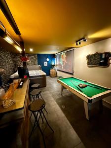 a room with a pool table and a bar at La Comète - Le Mont Dore 4 pers in Le Mont-Dore