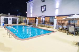 a swimming pool in front of a building at night at Comfort Inn & Suites in Schulenburg