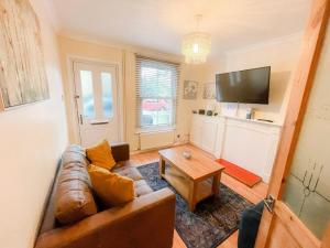 a living room with a couch and a table at Sittingbourne Terrace in Sittingbourne