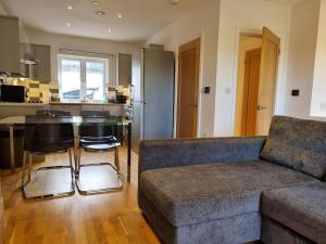 a living room with a couch and a kitchen at Cliffe Terrace W 1 Free Parking Space in Chatham