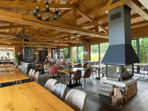 a restaurant with a fireplace and tables and chairs at Charming comfortable apartment at Cornelia Deluxe Residence with free pool and SPA in Razlog