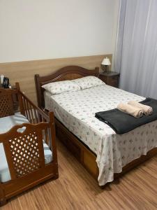 a bedroom with a bed and a chair next to it at Quinto do Tijuco in Diamantina