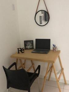 里约热内卢Apt a 650 m da praia do recreio的一张带笔记本电脑、椅子和镜子的桌子