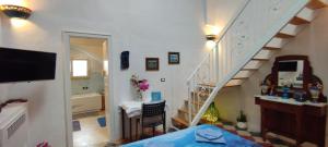 a living room with a staircase and a bathroom at Dimora Maltese in Morciano di Leuca