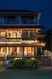 a building with balconies on the side of it at Sunfun Beach House in Kannur