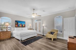 a bedroom with a bed and a chair at Miramar Magic in Destin +75 photos