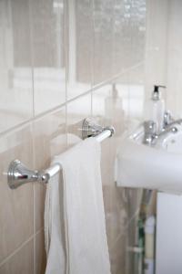 a bathroom with a white towel hanging from a sink at Colney Lane Lodge in Colney