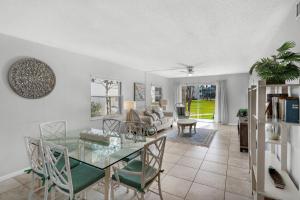 a living room with a glass table and chairs at El Matador- Beachside Haven 210 in Fort Walton Beach