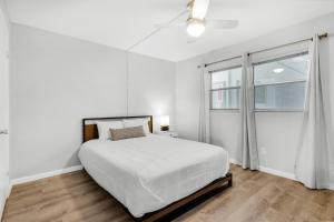 a white bedroom with a large bed and a window at El Matador- Beachside Haven 210 in Fort Walton Beach +47 photos