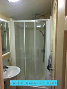 a bathroom with a shower and a sink at 2 bedroom 6 berth Caravan Towyn Rhyl in Kinmel Bay