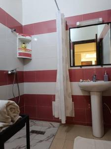 a bathroom with a sink and a mirror at Cozy sunny apartment in Sale