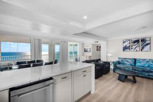a kitchen and living room with a view of the ocean at Shoreline Towers 2086 in Destin