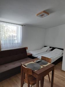 a living room with a couch and a table at U Adama in Wieliczka