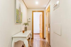 a white desk in a room with a hallway at Precioso piso in Catarroja