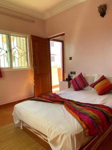 a bedroom with a large bed and a window at Titanic House by ahmed in Mirleft