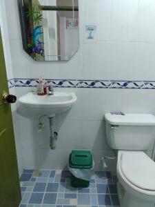 a bathroom with a toilet and a sink at Hospedaje la Viña in El Cerrito