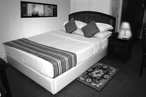 a black and white photo of a bed in a bedroom at city Homes in Dhaka