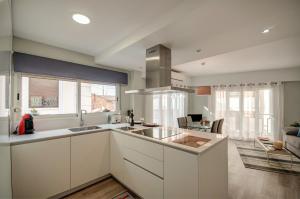 a kitchen with white cabinets and a counter top at Beds & Breaks Casals in Valencia