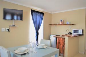 a dining room with a table and a window at Point Village Hotel and Self Catering in Mossel Bay