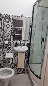 a bathroom with a toilet and a sink and a shower at Casa Sofia in Catania