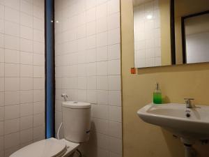 a bathroom with a toilet and a sink at Kuta Living in Kuta