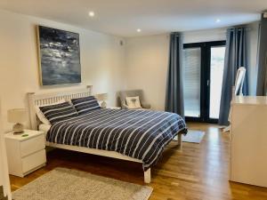 1 dormitorio con 1 cama y 1 silla en Independent rural detached annexe with free private Parking, en Canterbury