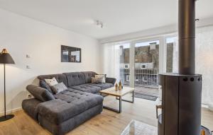 a living room with a couch and a fireplace at Gebirgsresort Winterberg in Winterberg