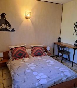 a bed with two pillows in a bedroom at Ferme La Siberie in Entrevaux