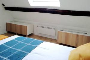 a bedroom with a bed and two cabinets and a window at The Cozy Downtown Duplex in Chevreuse