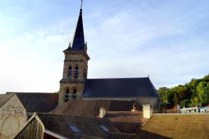 a church with a steeple and a building with roofs at The Cozy Downtown Duplex in Chevreuse