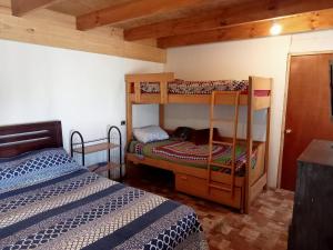 a bedroom with two bunk beds and a bed at MarAzul in Valparaíso