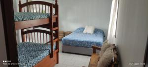 a room with two bunk beds and a chair at MarAzul in Valparaíso