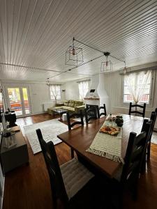 a living room with a wooden table and chairs at Wood House Valiug in Văliug