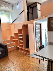 a room with a staircase with shelves and a table at Gallery in Belgrade