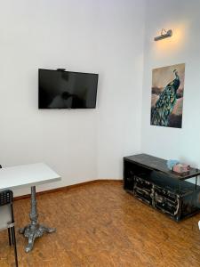 a white room with a tv on a wall with a table at Gallery in Belgrade