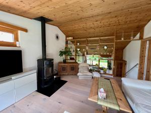 a living room with a stove and a couch at Chasa Stefania mit rundum Bergblick und Garten in Scuol