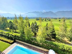 an overhead view of a swimming pool in a garden at Pirin Bliss Apartment Ski, Spa and Relax at Terra Complex in Razlog