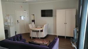 a living room with a table and a couch at Hotel Charlotte / Stella in Uppsala