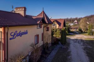 a building with a sign on the side of it at Pensjonat nad jeziorem Lakeside in Brodnica Dolna