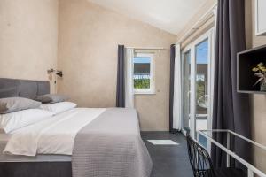 a bedroom with a bed and a window at Holiday home Nika in Sveti Ivan Dobrinjski +28 photos