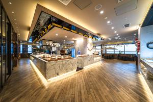 a restaurant with a counter in the middle of a room at Inchon sky and sea ocean view hotel in Incheon